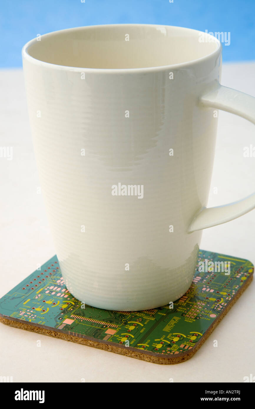 Pot mug on a square green coaster made from re cycled circuit boards Stock Photo