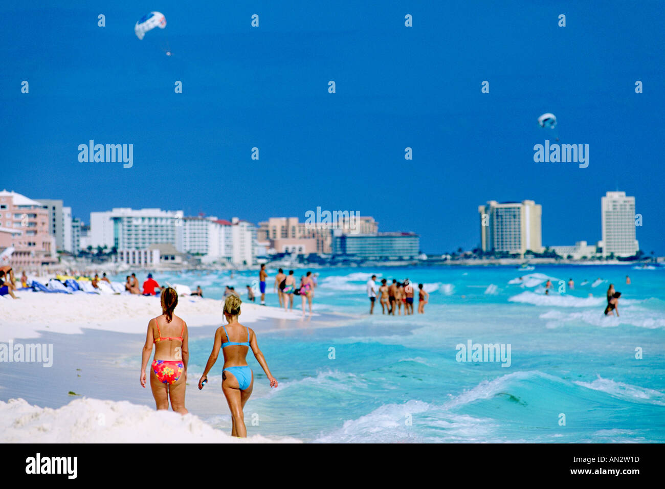Two bikiniclad women walking on the Cancun beach on Mexico's Stock