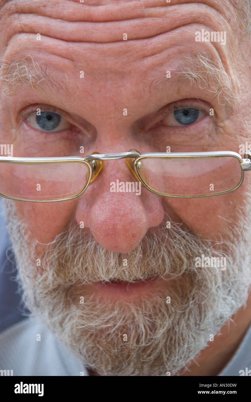 Bearded blue eyed older man with quizzical expression Stock Photo