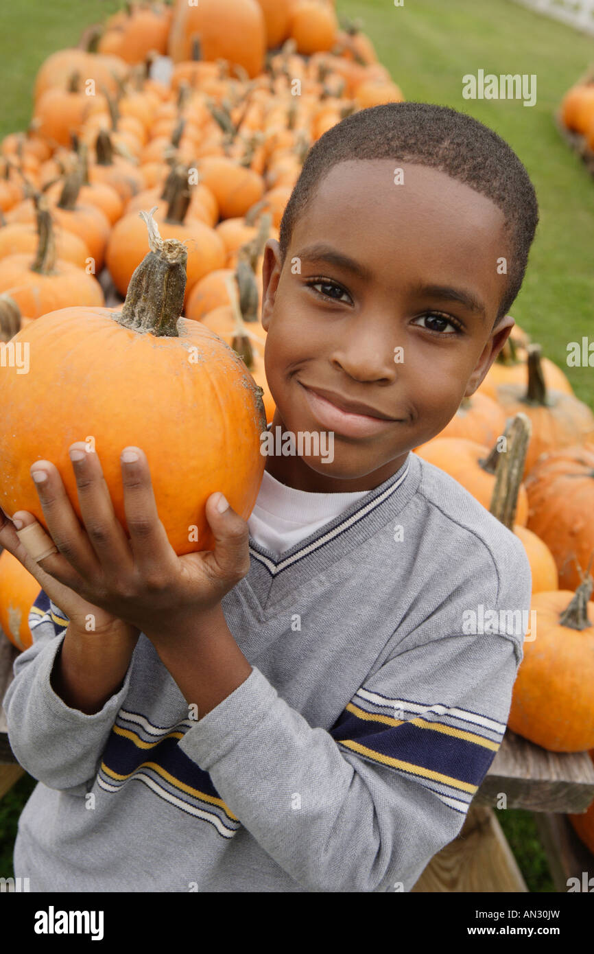 Portrait of African boy holding pumpkin Stock Photo - Alamy