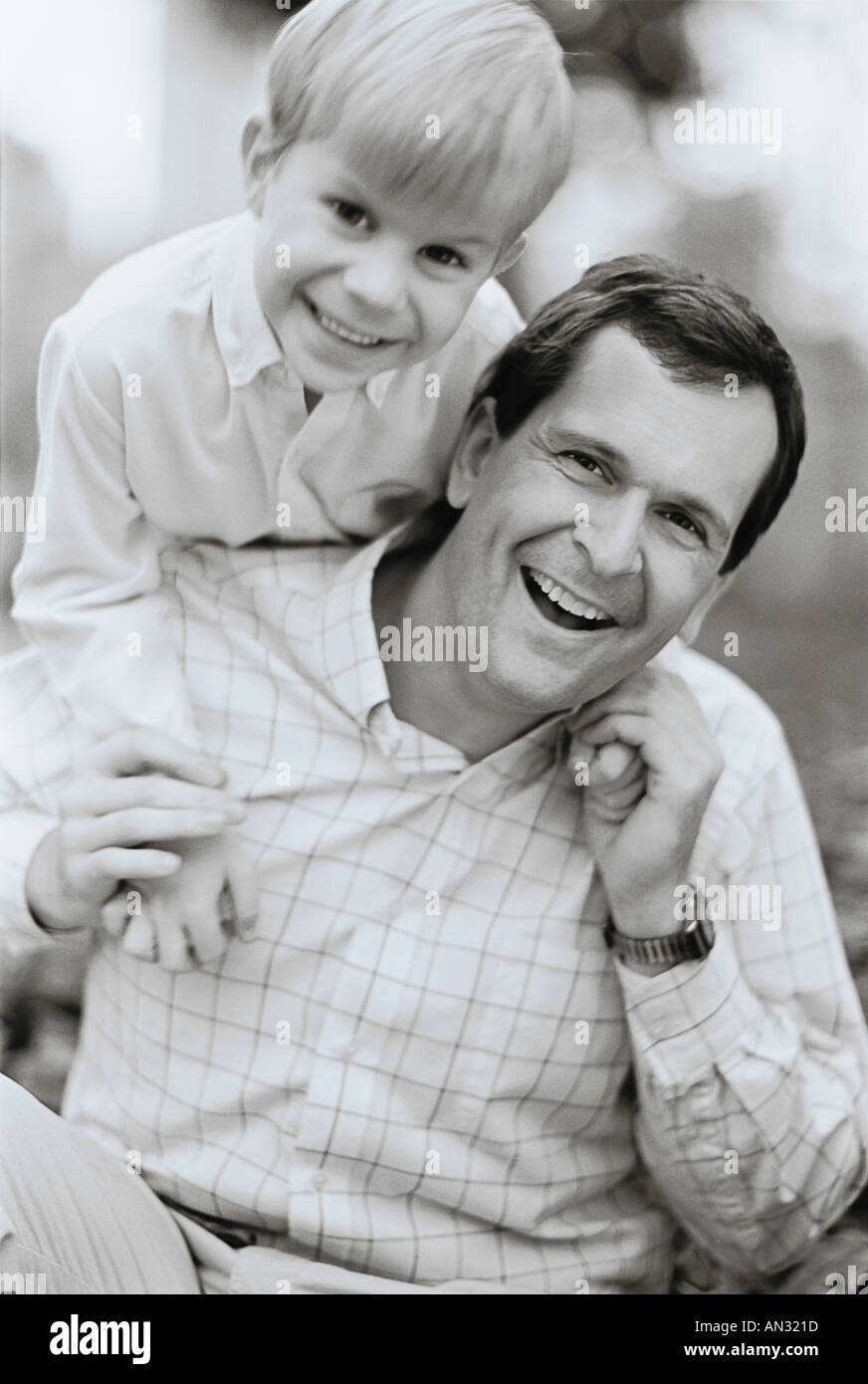 Black and white outdoors image of father and son smiling at camera ...