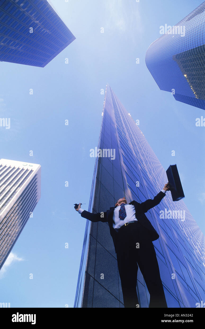 Businessman feeling victorious under Los Angeles skyscrapers Stock Photo