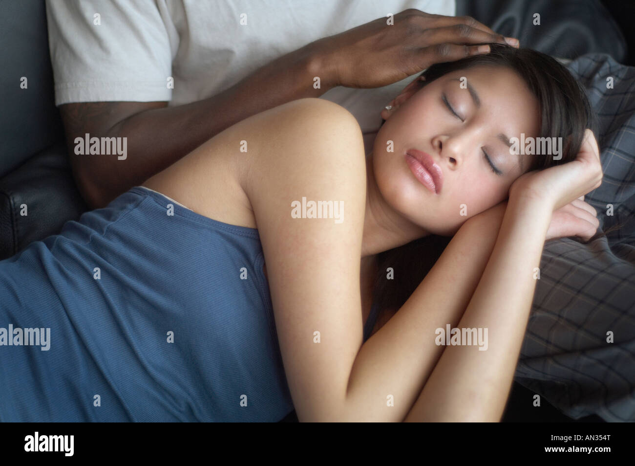 African couple sleeping on sofa hi-res stock photography and images - Alamy
