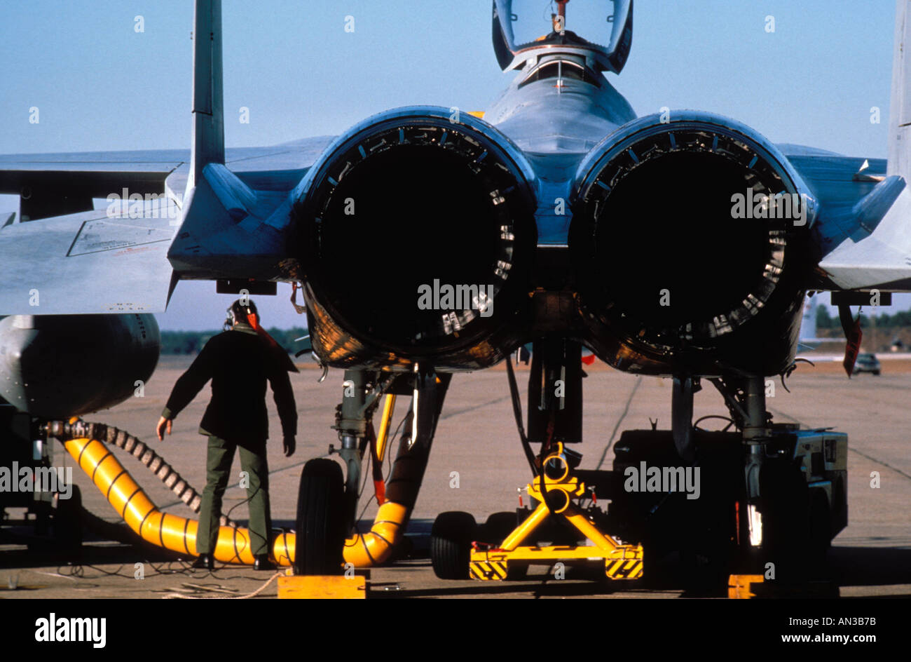Military maintenance worker checking tail end of Fighter Jet At Eglin