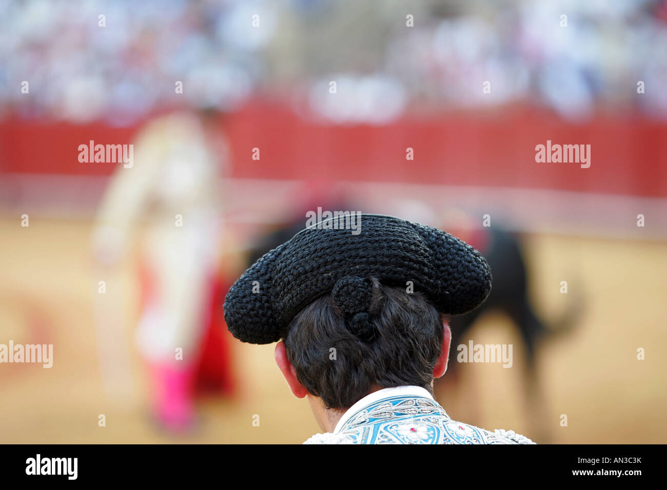 Assistant bullfighter watching a bullfight. Stock Photo