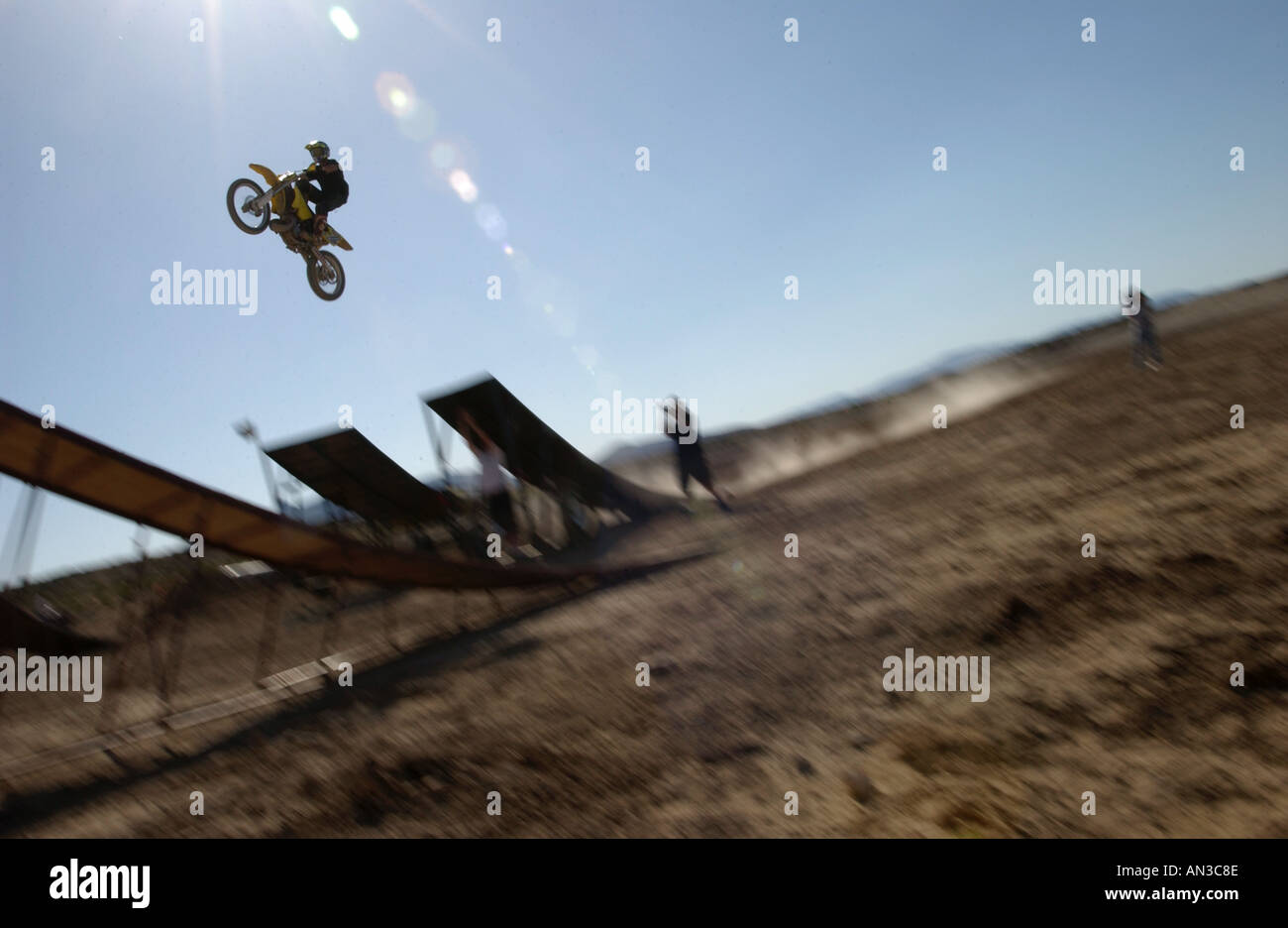Motocross riders jumping a ramp Stock Photo - Alamy