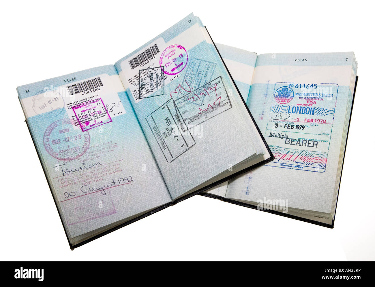 Two old style UK passports with port of entry stamps and a USA visa waiver Stock Photo