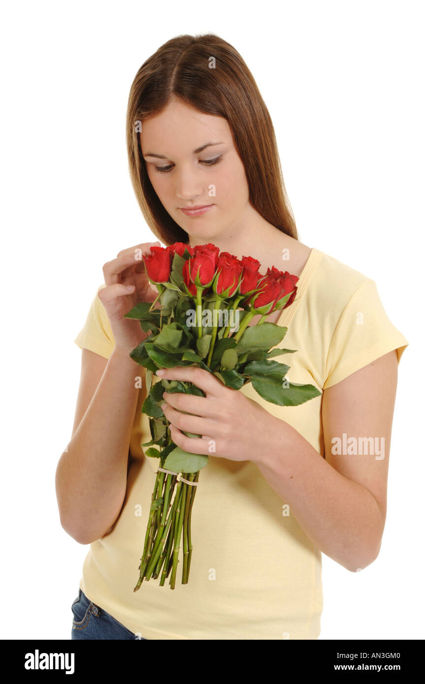 a teenage girl with a bunch of red roses smelling them Stock Photo - Alamy