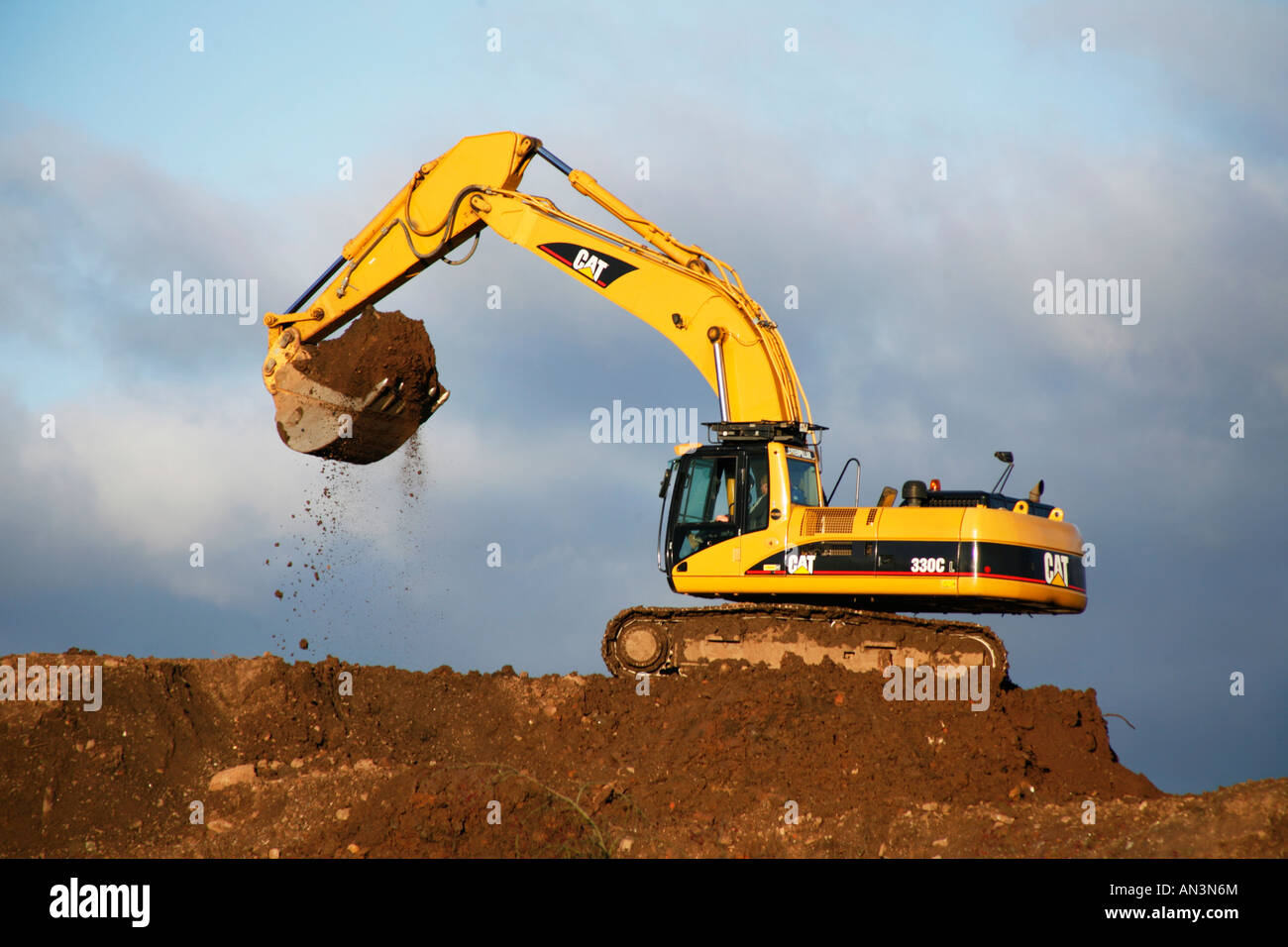 Caterpillar 330c tracked excavator at work on a building site excavating soil Stock Photo