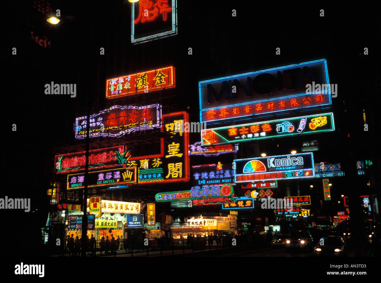 Hong Kong street scene lit up by neon signs at night time Stock Photo