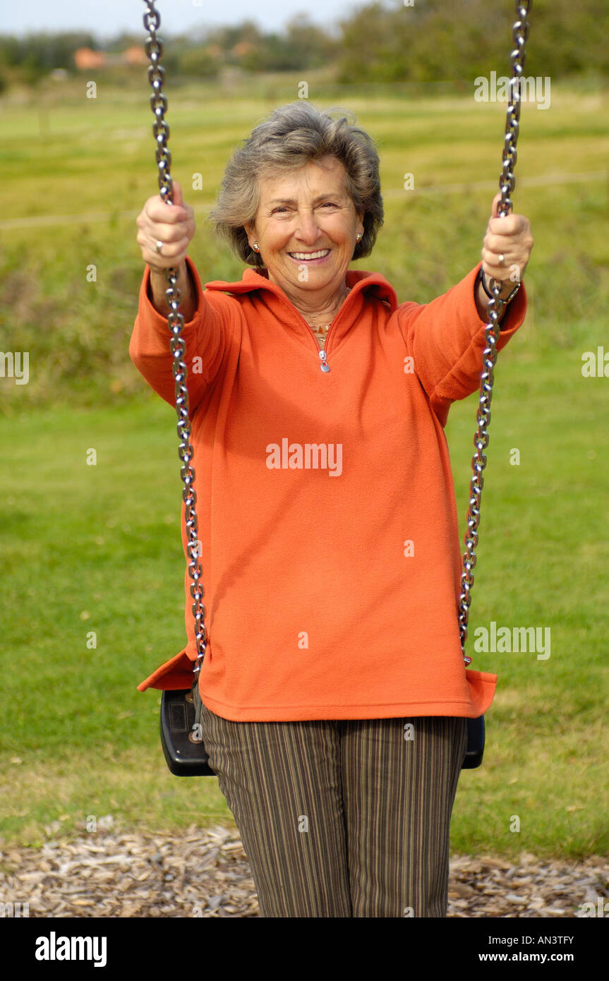 Older woman swinging hi-res stock photography and images - Alamy