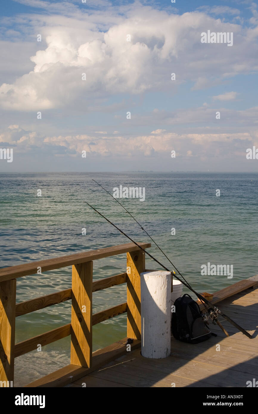 Fishing poles aganist railing on City Pier on Anna Maria Island on the