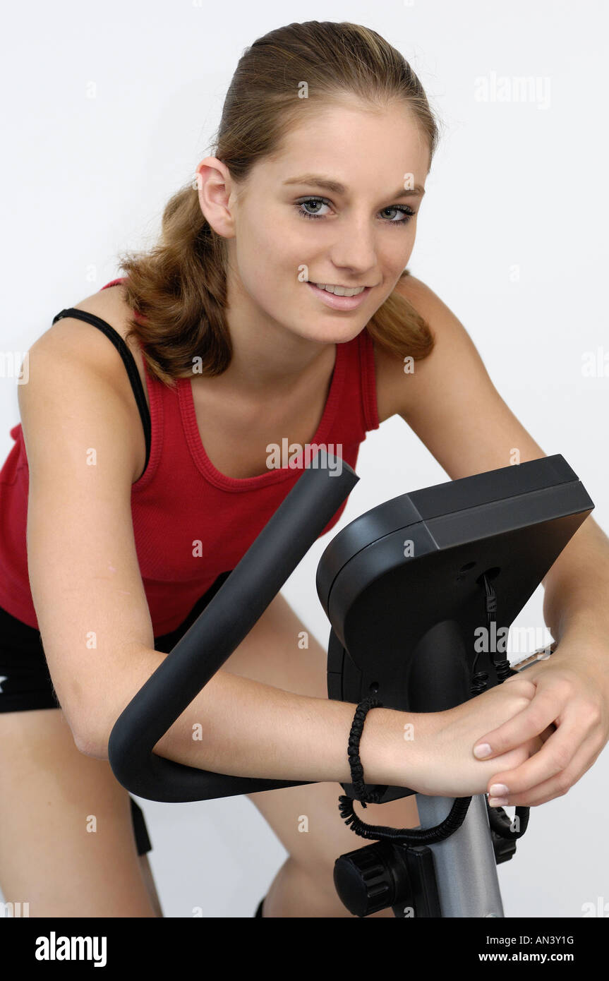 young woman on exercise bicycle Stock Photo