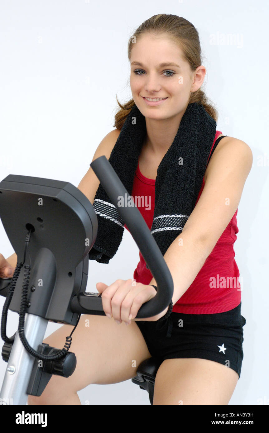 young woman on exercise bicycle Stock Photo