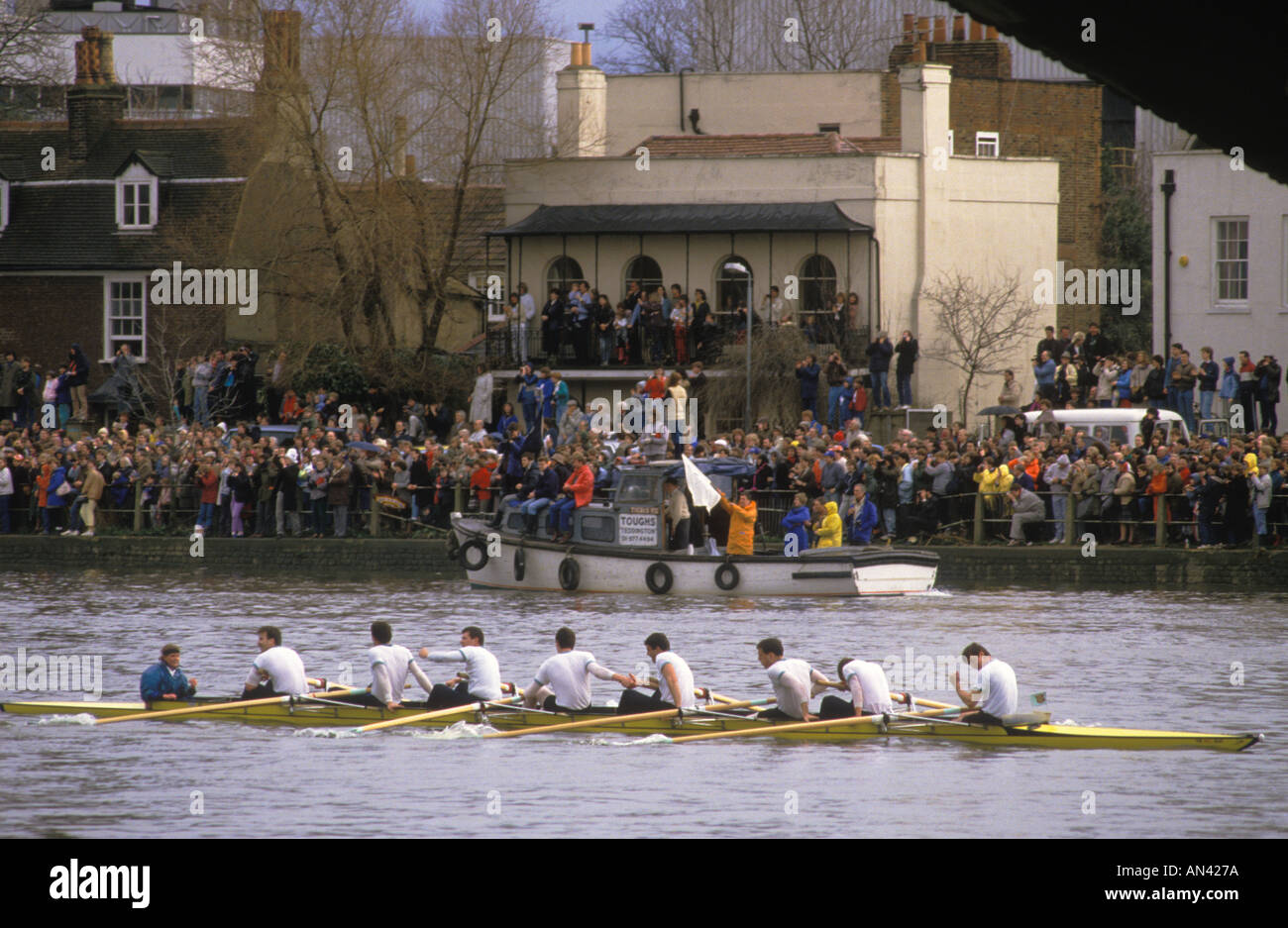 Carole Burton Boat Race River Thames London. Oxford v Cambridge University. Cambridge win1986. Shaking hands Mortlake finishing line. 1980s UK  HOMER Stock Photo