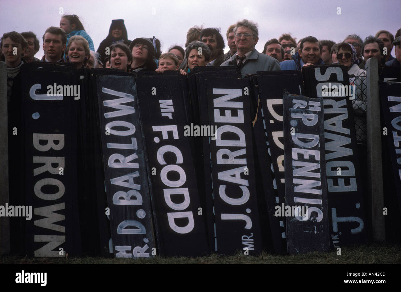 Aintree Grand National horse race 1980s. Spectators line up behind the jockeys name boards 80s UK HOMER SYKES Stock Photo