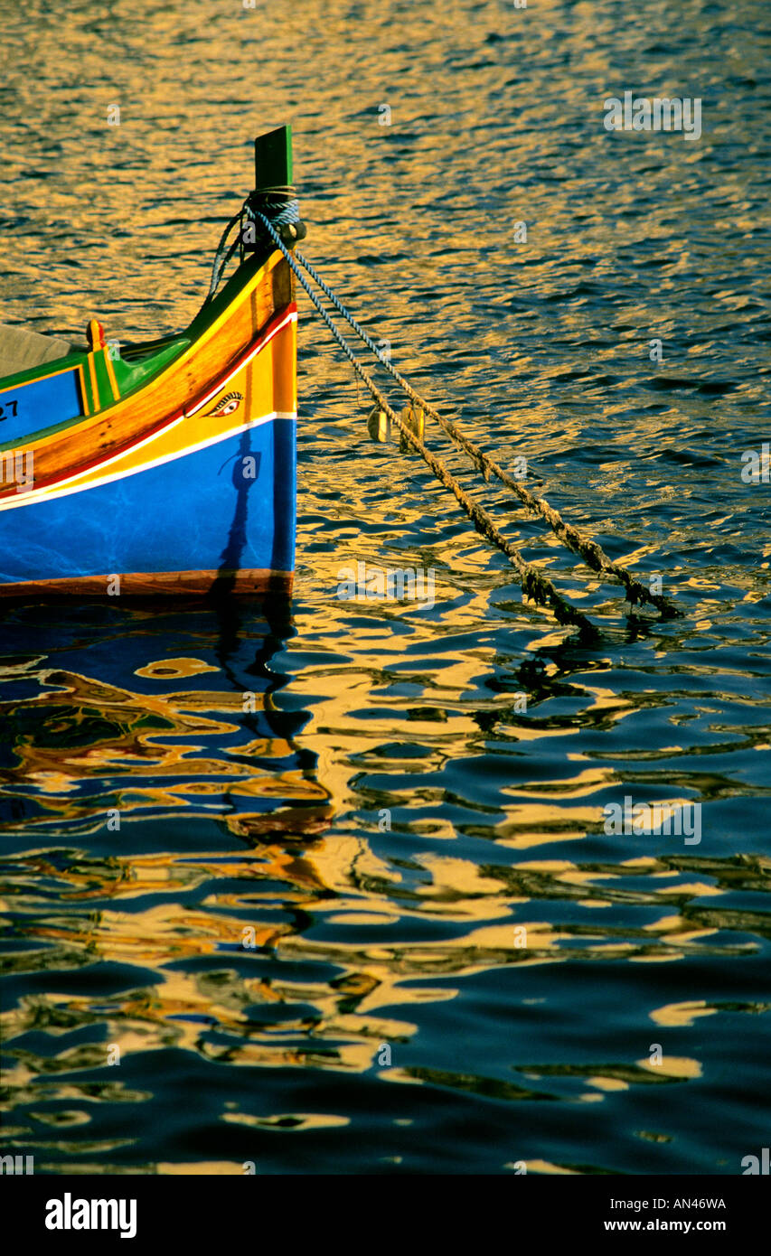 Typical Luzzu fishing boat, Malta, Europe at sunset Stock Photo