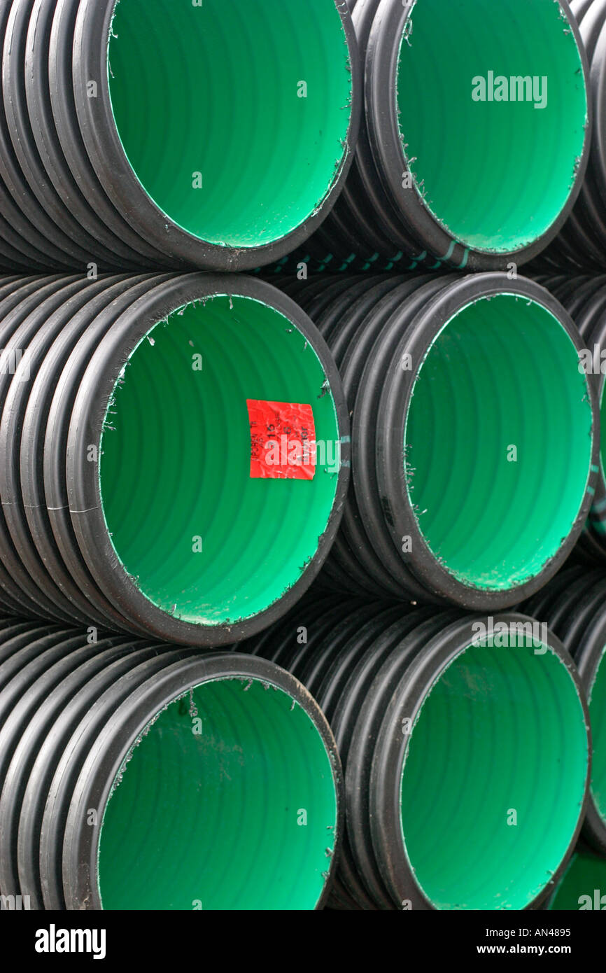Inventory of PVC drainage pipes / culverts with green interior in stack Stock Photo