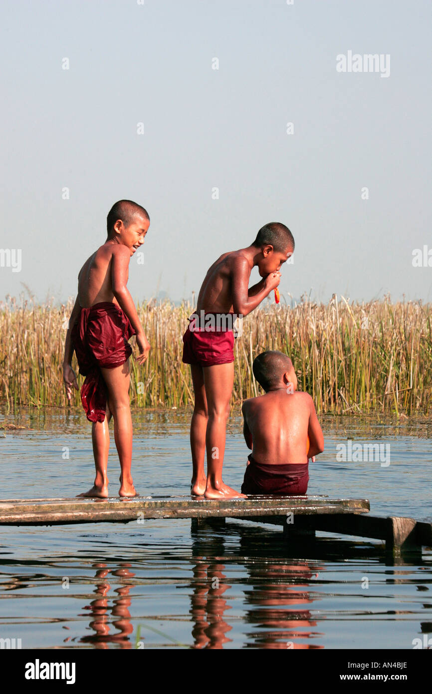 Novice Buddhist monks enjoying a bath at a tributary of Inle Lake, near