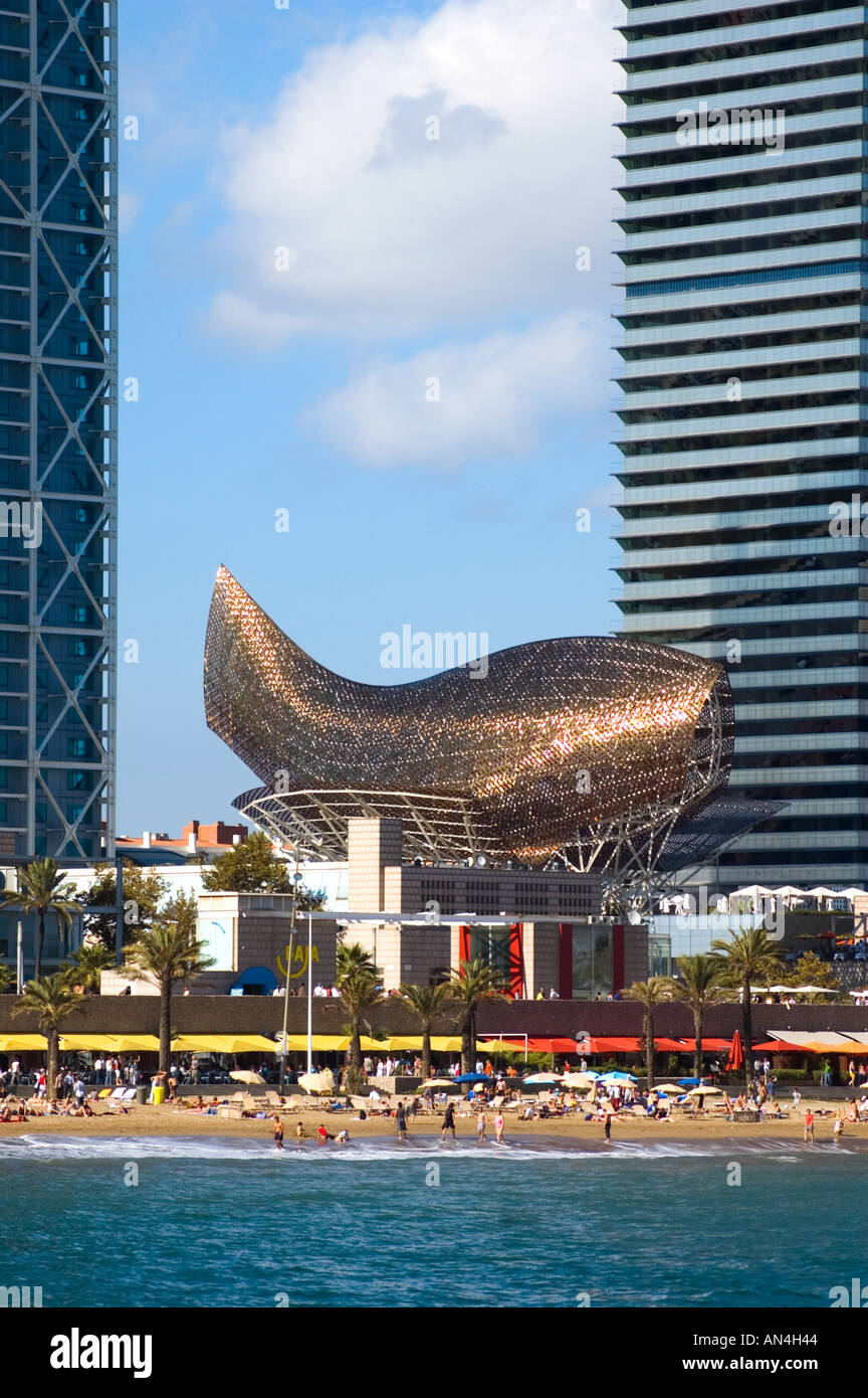 Architect Frank Gehrys Peix gold fish structure by between Torre Mapfre and Hotel Arts in Port Olimpic Barcelona Spain Stock Photo