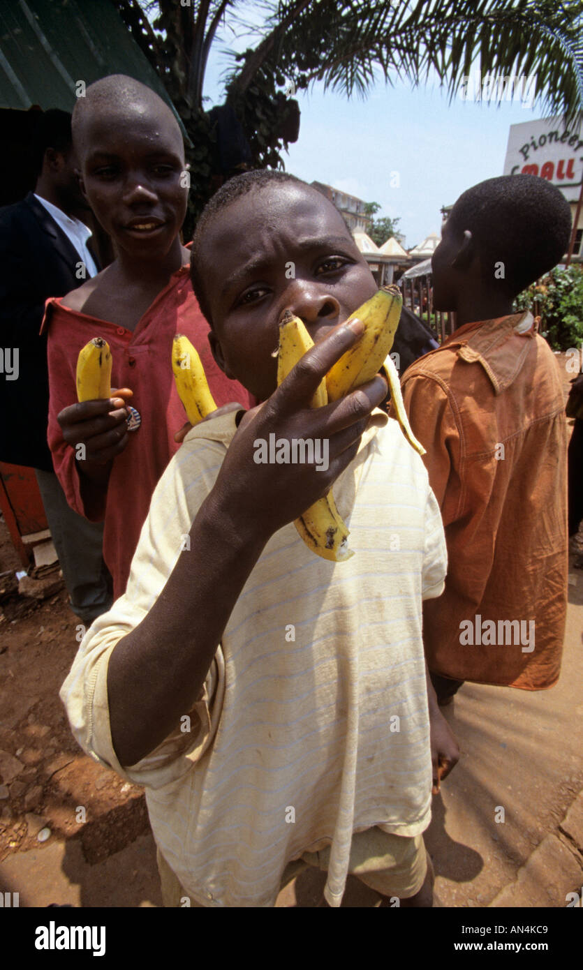 Boys eating bananas on street, Kampala, Uganda, Africa Stock Photo Alamy