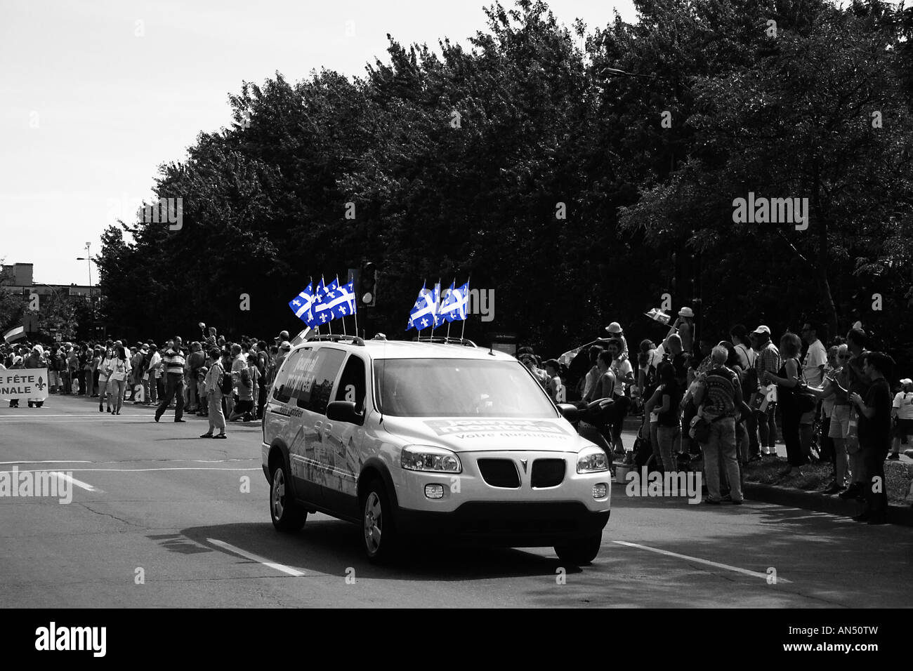 Van driving through parade Stock Photo Alamy