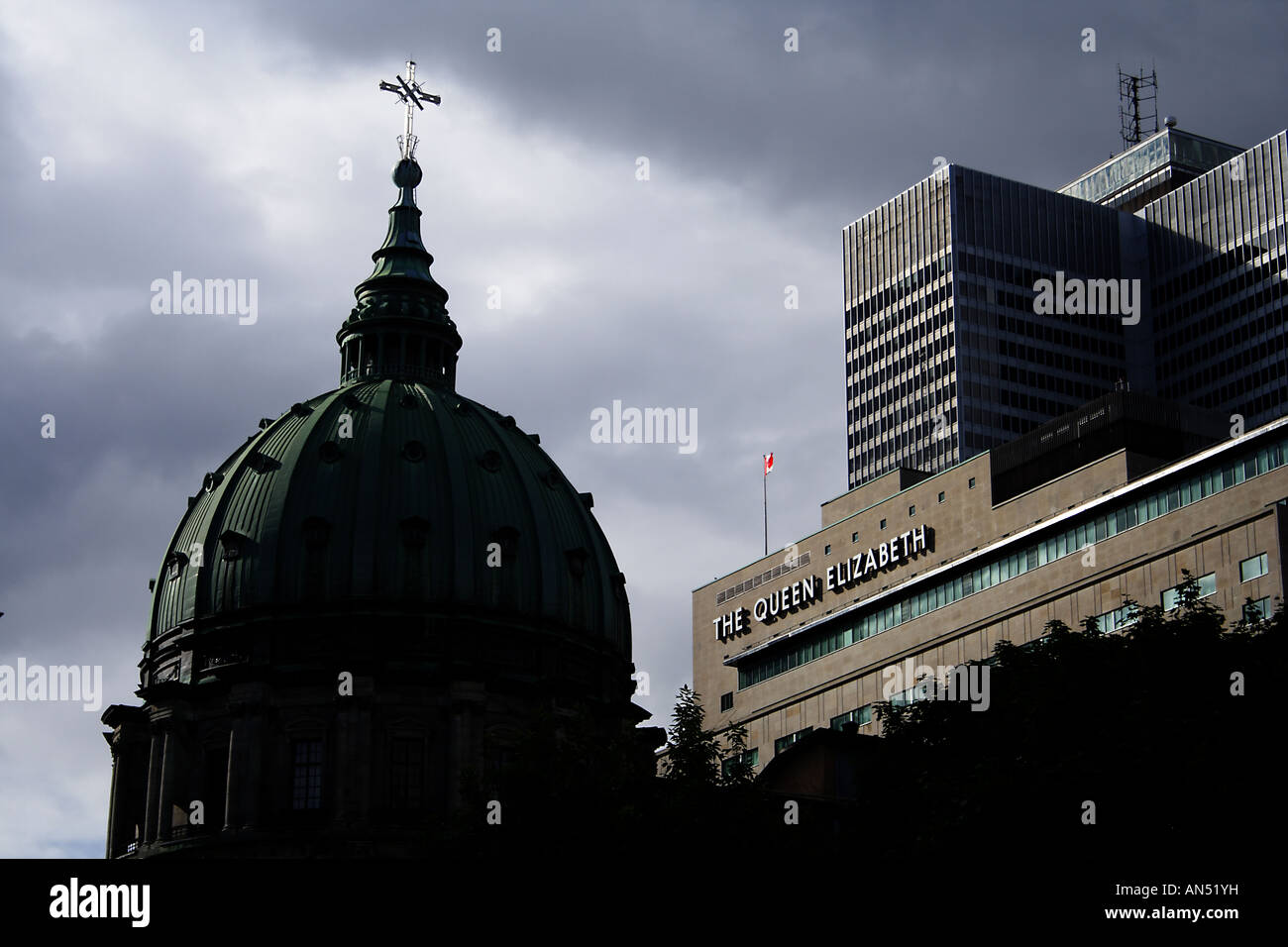 The dome of a catholic church in Montreal Canada with the Queen Elizabeth Hotel behind it Stock Photo