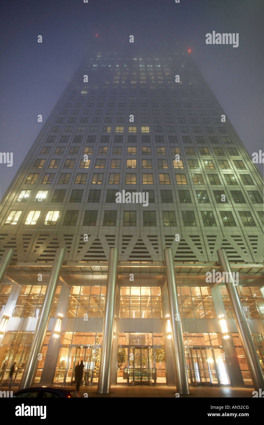 Night View Of One Canada Square Office Building Rising Into Fog In night-view-of-one-canada-square-office-building-rising-into-fog-in