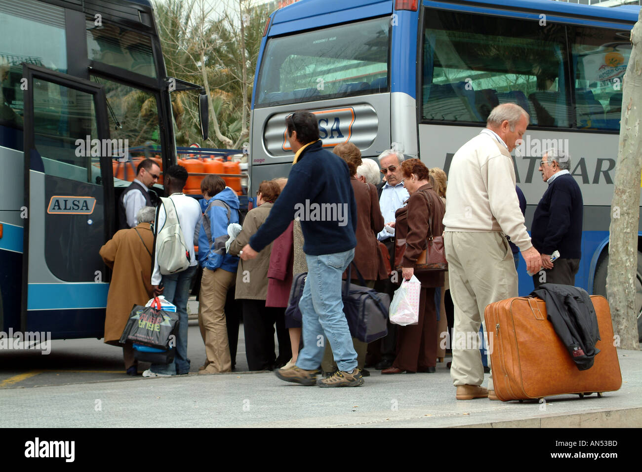 Coach Passengers with Luggage in Benidorm Spain Espana ELSA Stock Photo
