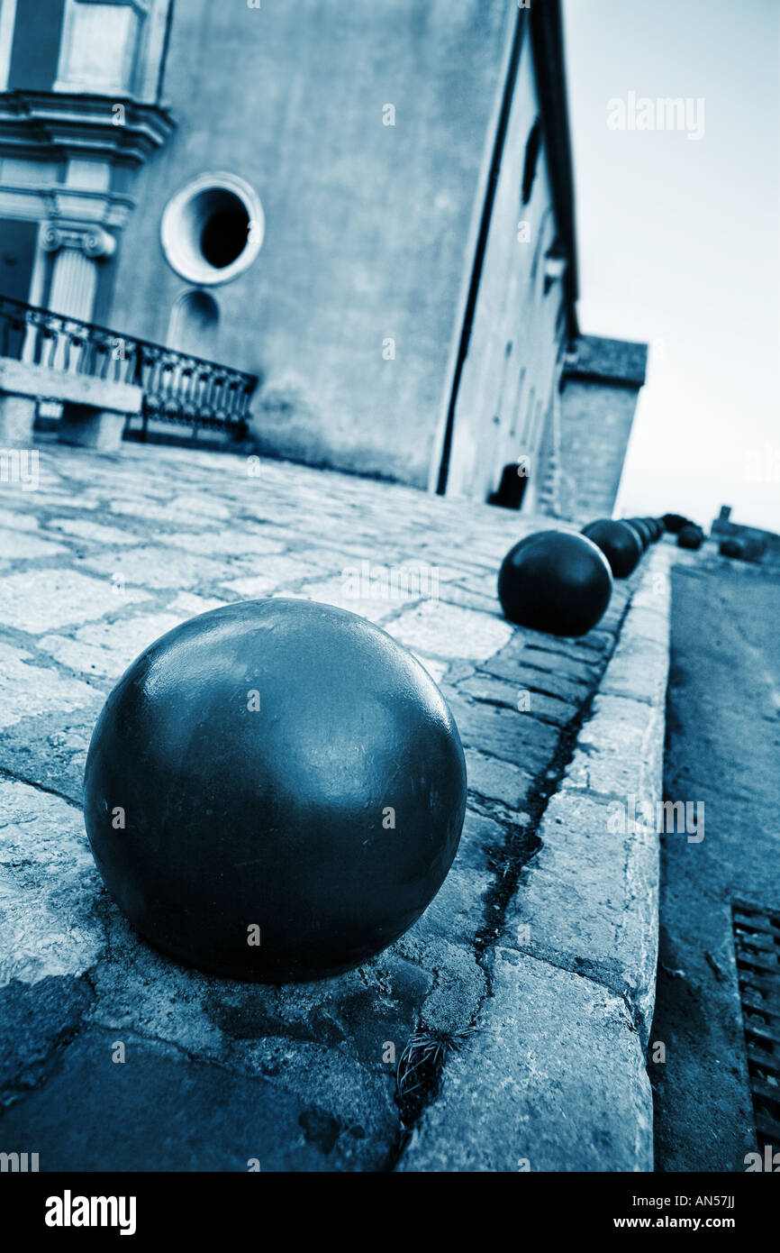 Iron balls and building in the background in Antibes France Shallow D O F Blue tone Stock Photo