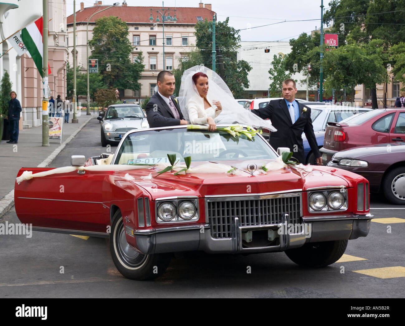 married couple posing for wedding photographs in Cadillac, Szeged, Hungary Stock Photo