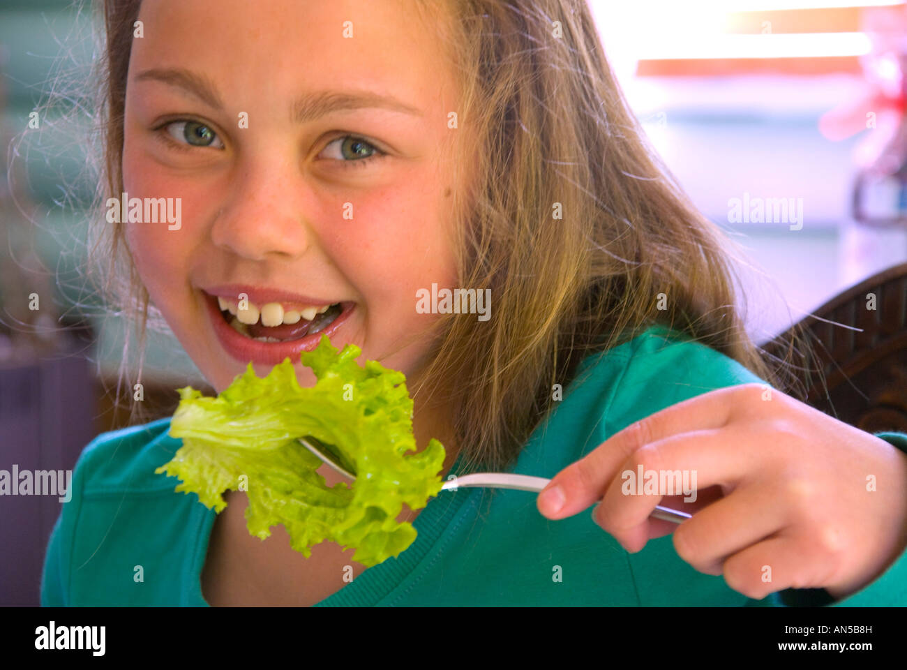 Young girl eating lettuce Stock Photo Alamy