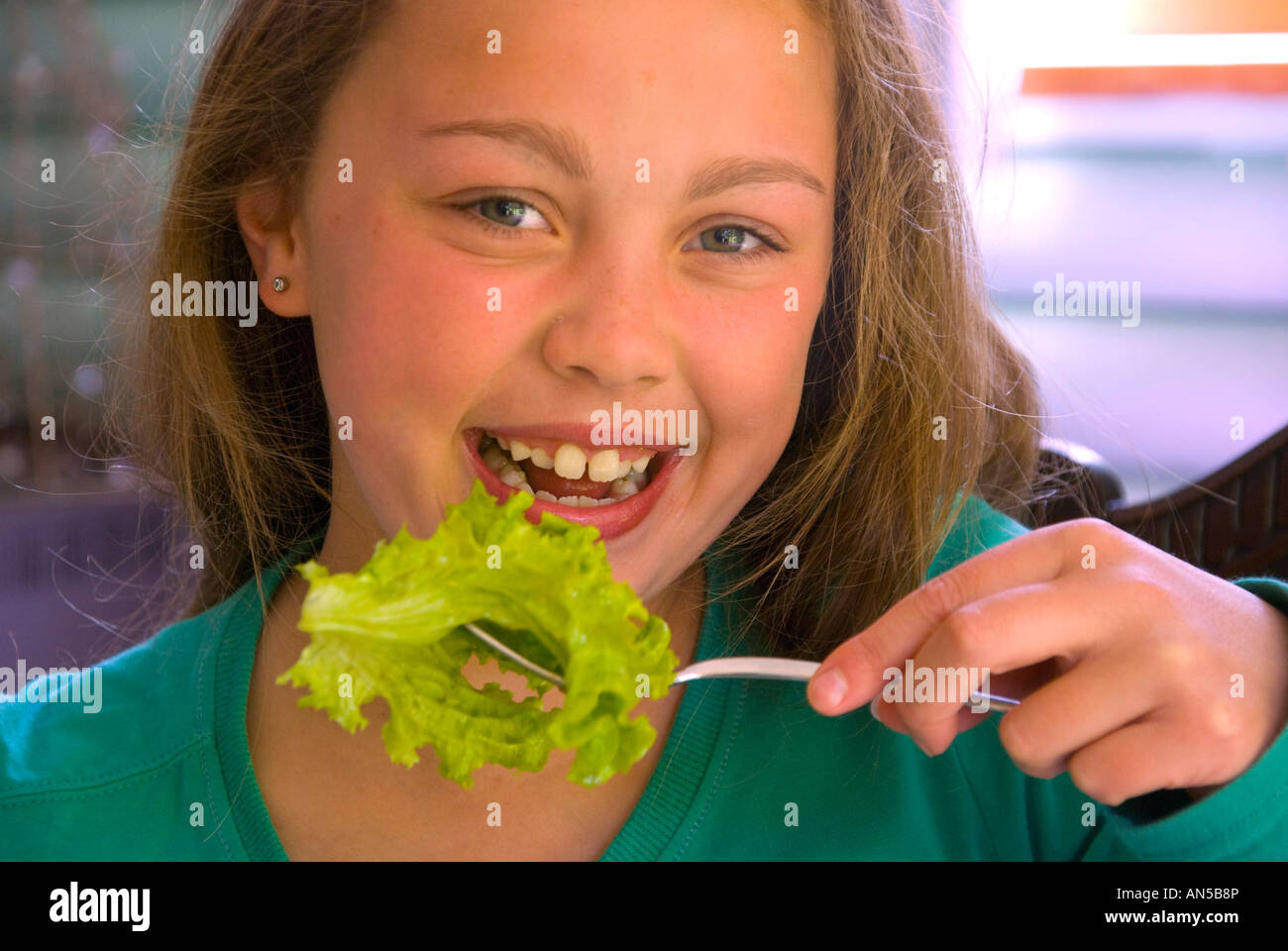 Young girl eating lettuce Stock Photo Alamy