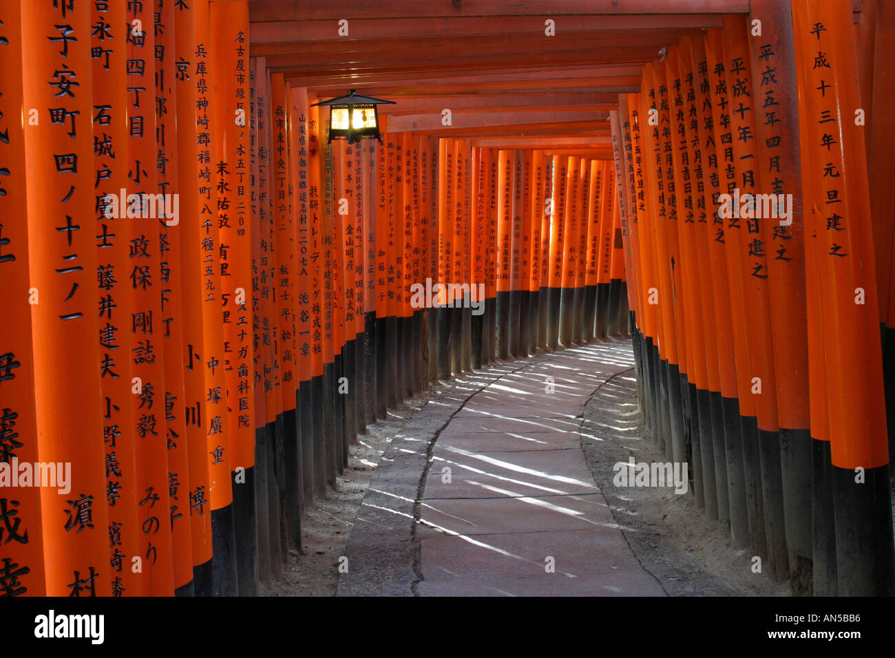 Bright orange traditional Tori gates at Fushimi Inari Taisha shrine in Kyoto Japan Asia scene set of Memoirs of a Geisha Stock Photo