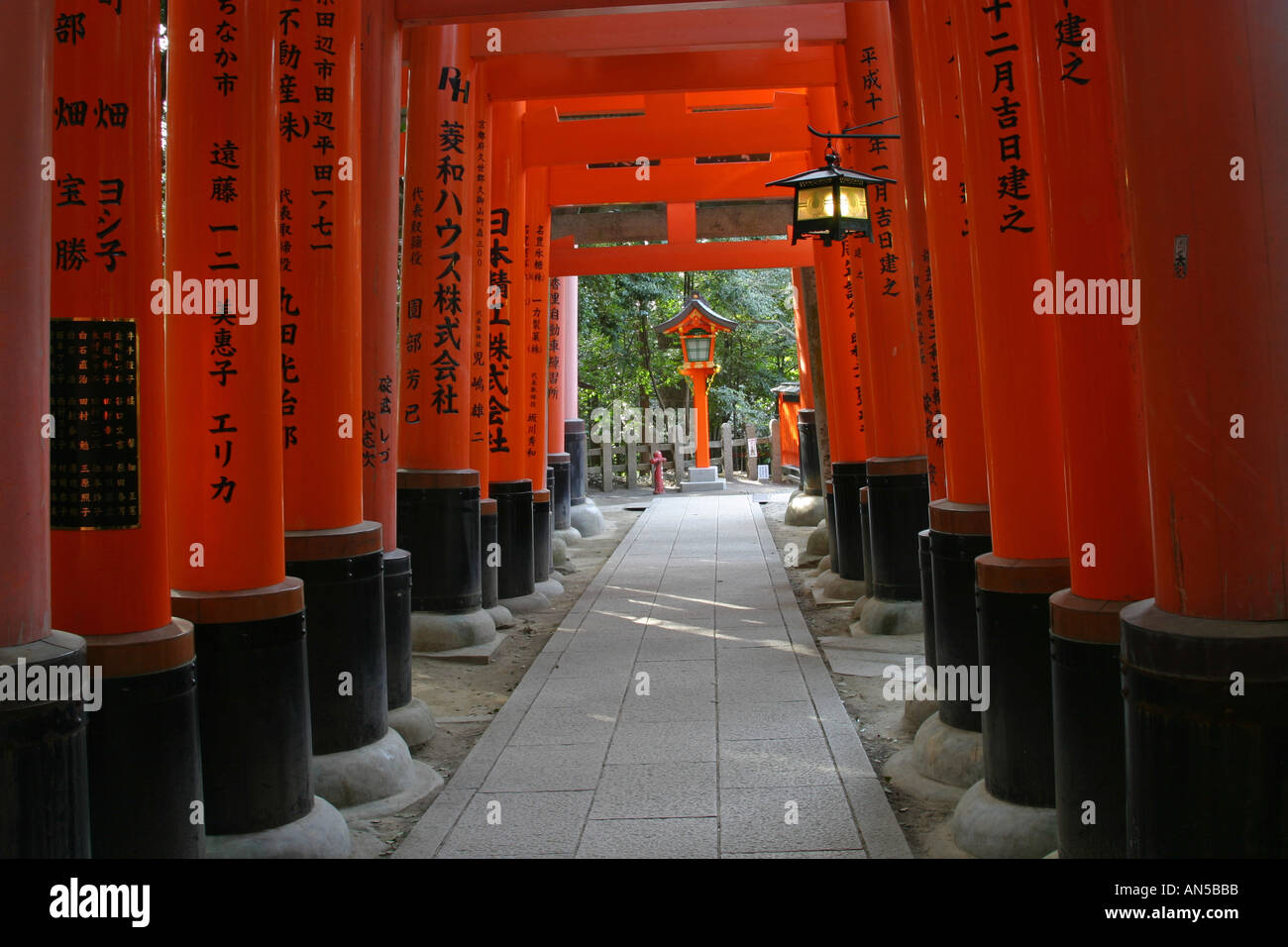 Famous Kyoto tourist attraction bright orange traditional religious Tori gates at Fushimi Inari Taisha shrine Kansai Japan Asia Stock Photo