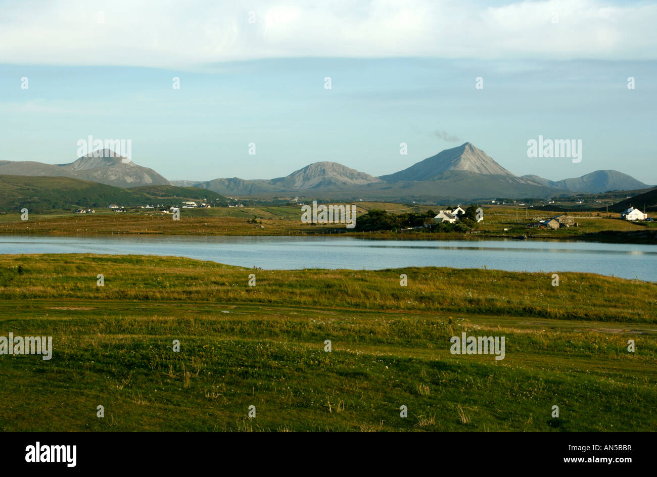 Mount Errigal (and some of the 'Seven Sisters' at sunset from Magheroarty Spit, Donegal, Ireland Stock Photo