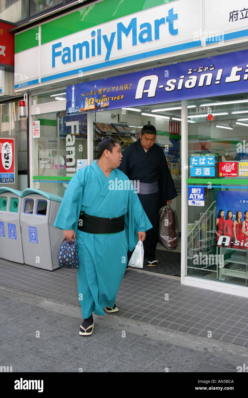 Two sumo wrestlers coming out of a convenience store on their way to fight at the Osaka spring sumo tournament in Japan Stock Photo