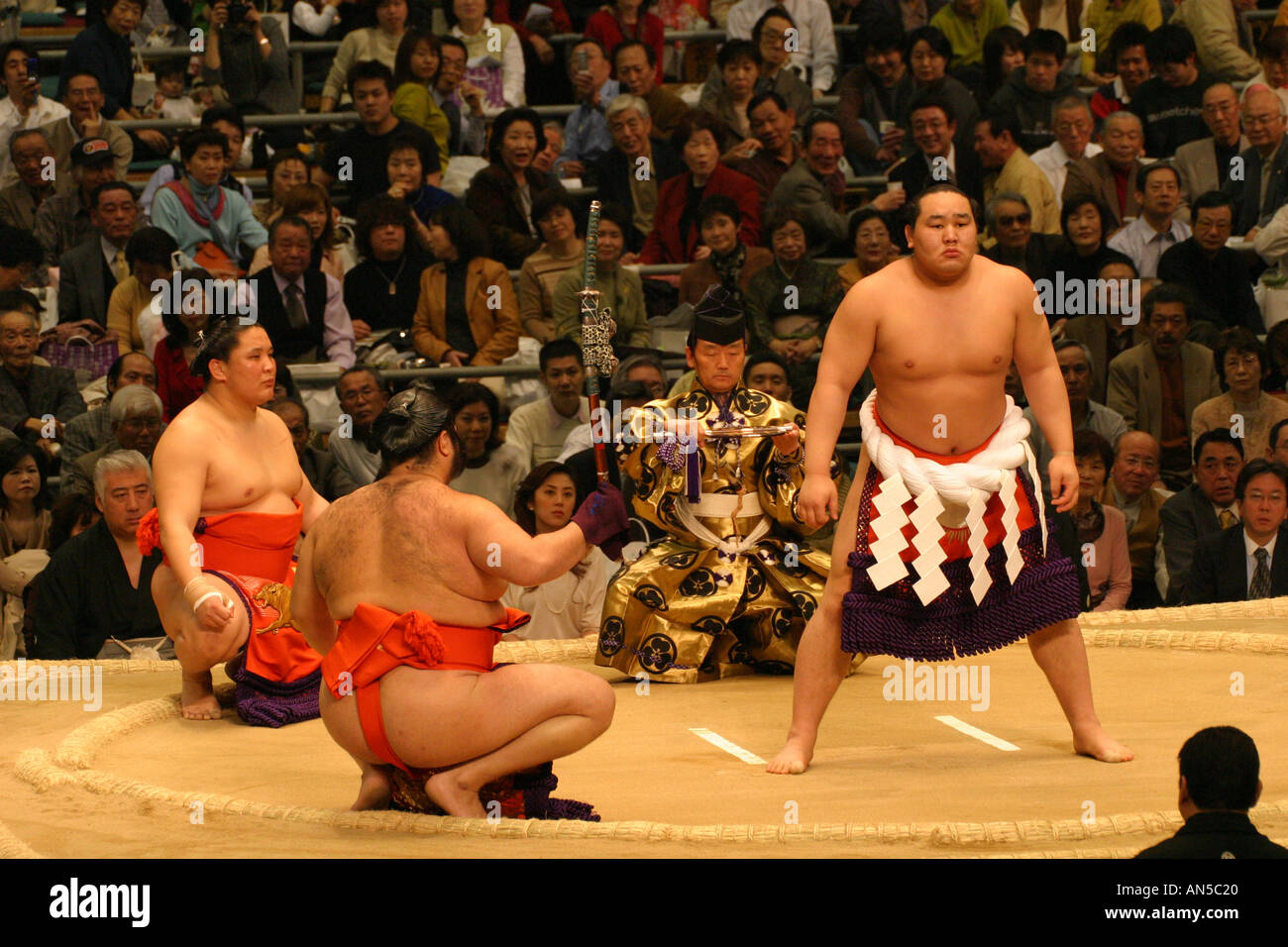 Sumo wrestlers and Yokazuna Grand champion conduct a pre fight ceremony