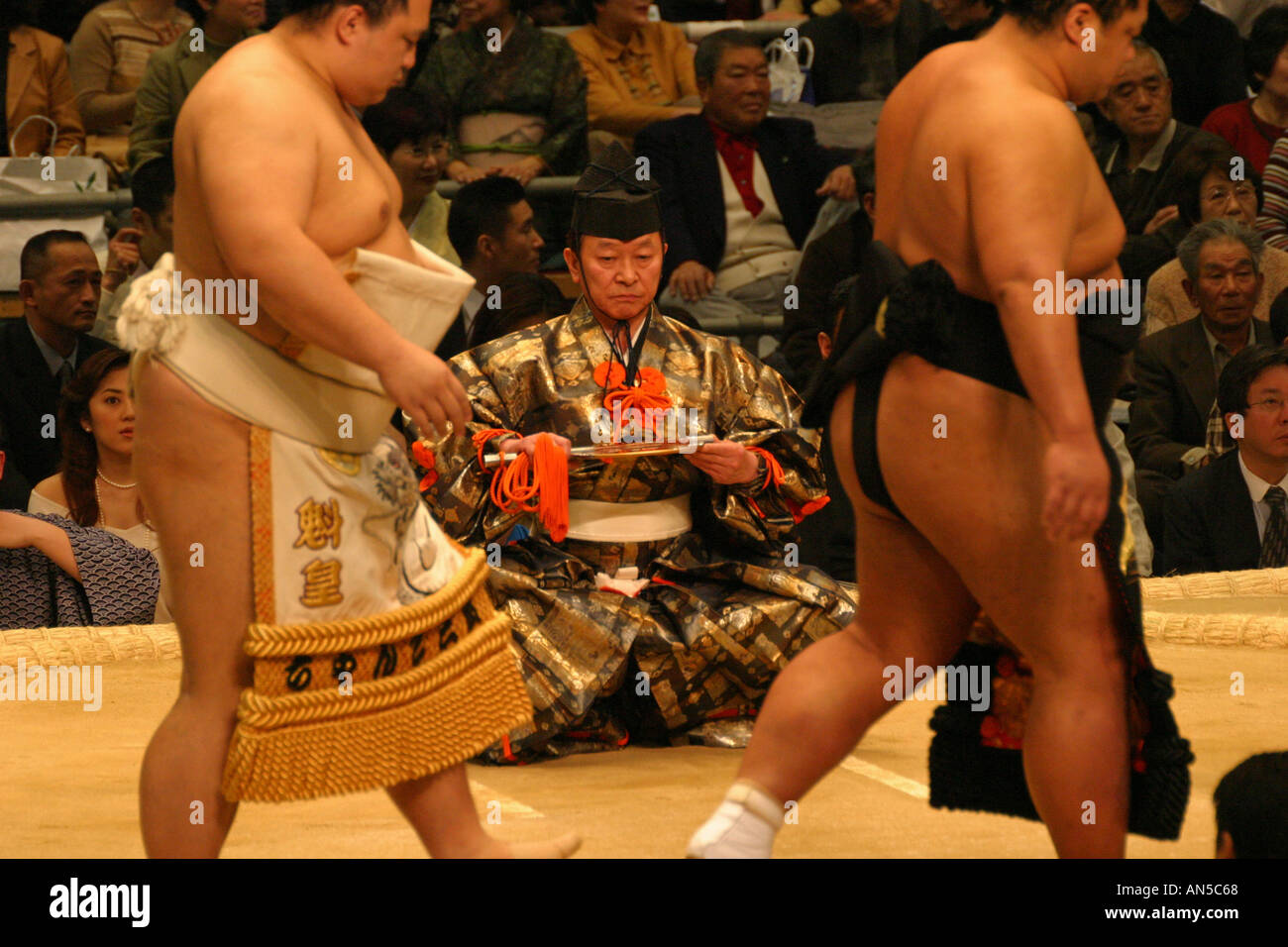Sumo wrestlers enter the clay ring for the pre fight ceremony at the Spring sumo tournament in Osaka Japan Asia Stock Photo