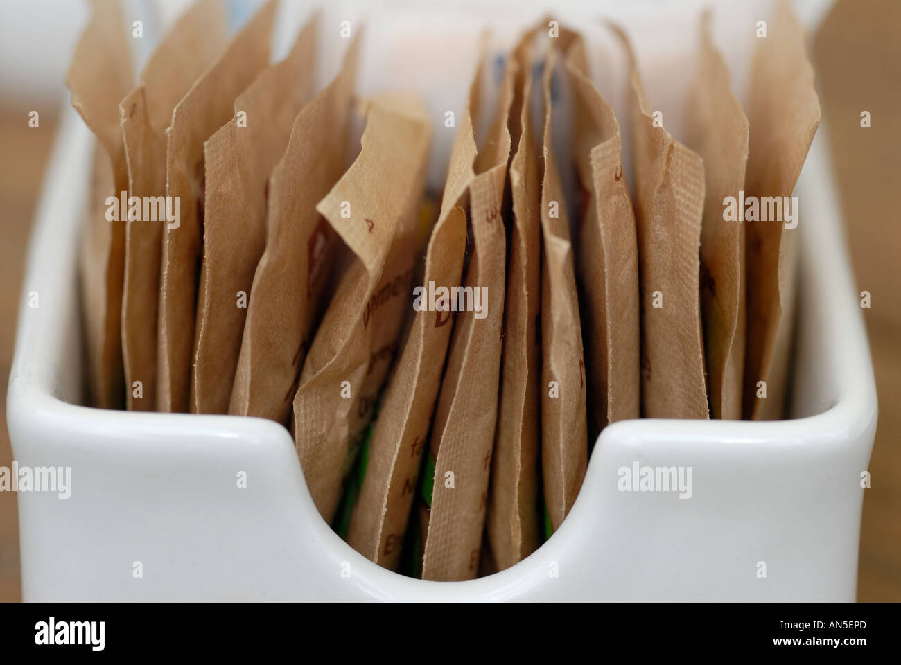 Sachets of sugar in a ceramic container Stock Photo Alamy