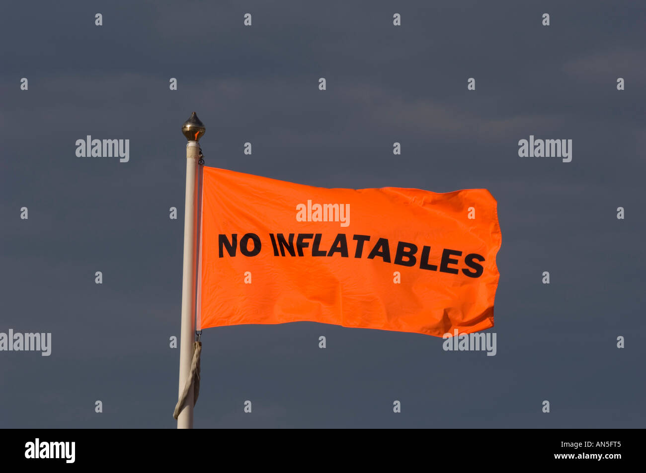 No inflatables warning flags on the seafront against a dark threatening ...