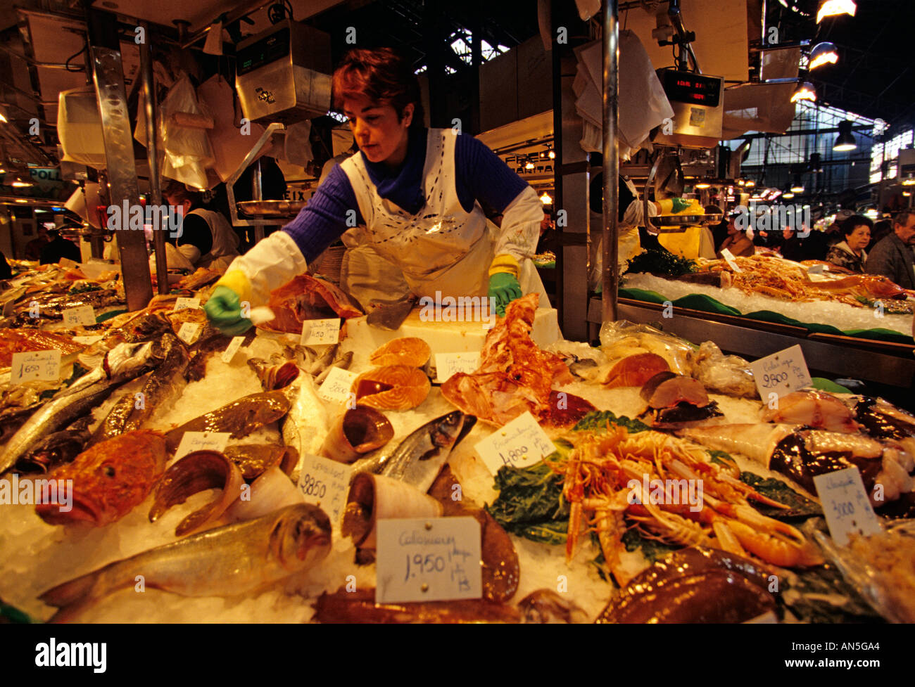 Vendors in seafood market, Barcelona Stock Photo