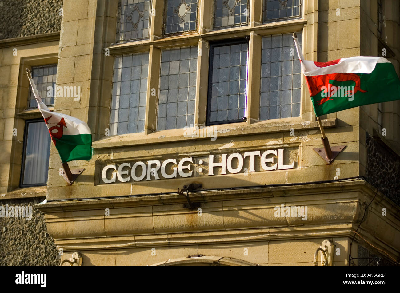 george hotel criccieth gwynedd north wales with red dragon welsh flag banner flying Stock Photo