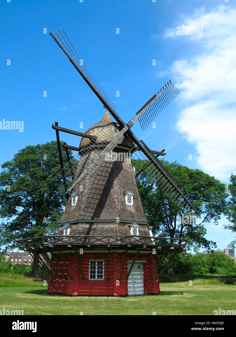 Old Swedish windmill with trees and clear blue sky background in Skane