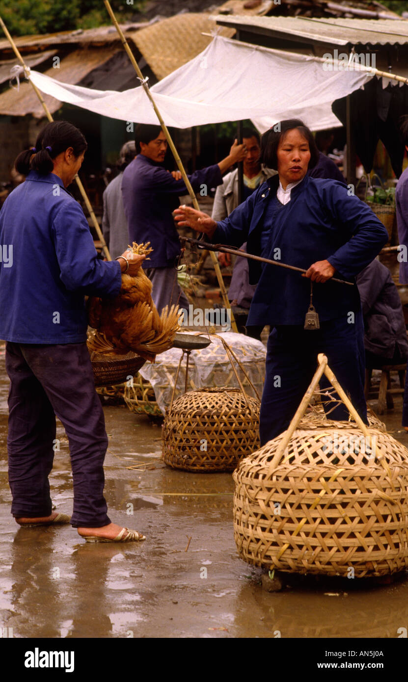 Women in market with baskets  Yangshuo village, Guangxi China in traditonal dress Stock Photo