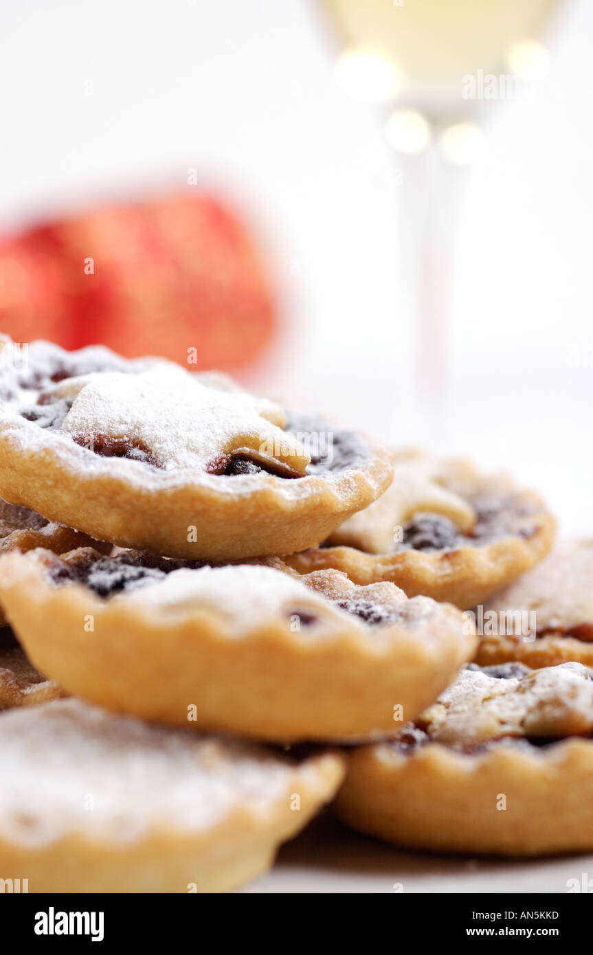 Plate of mince pies dusted with icing sugar with christmas cracker and ...