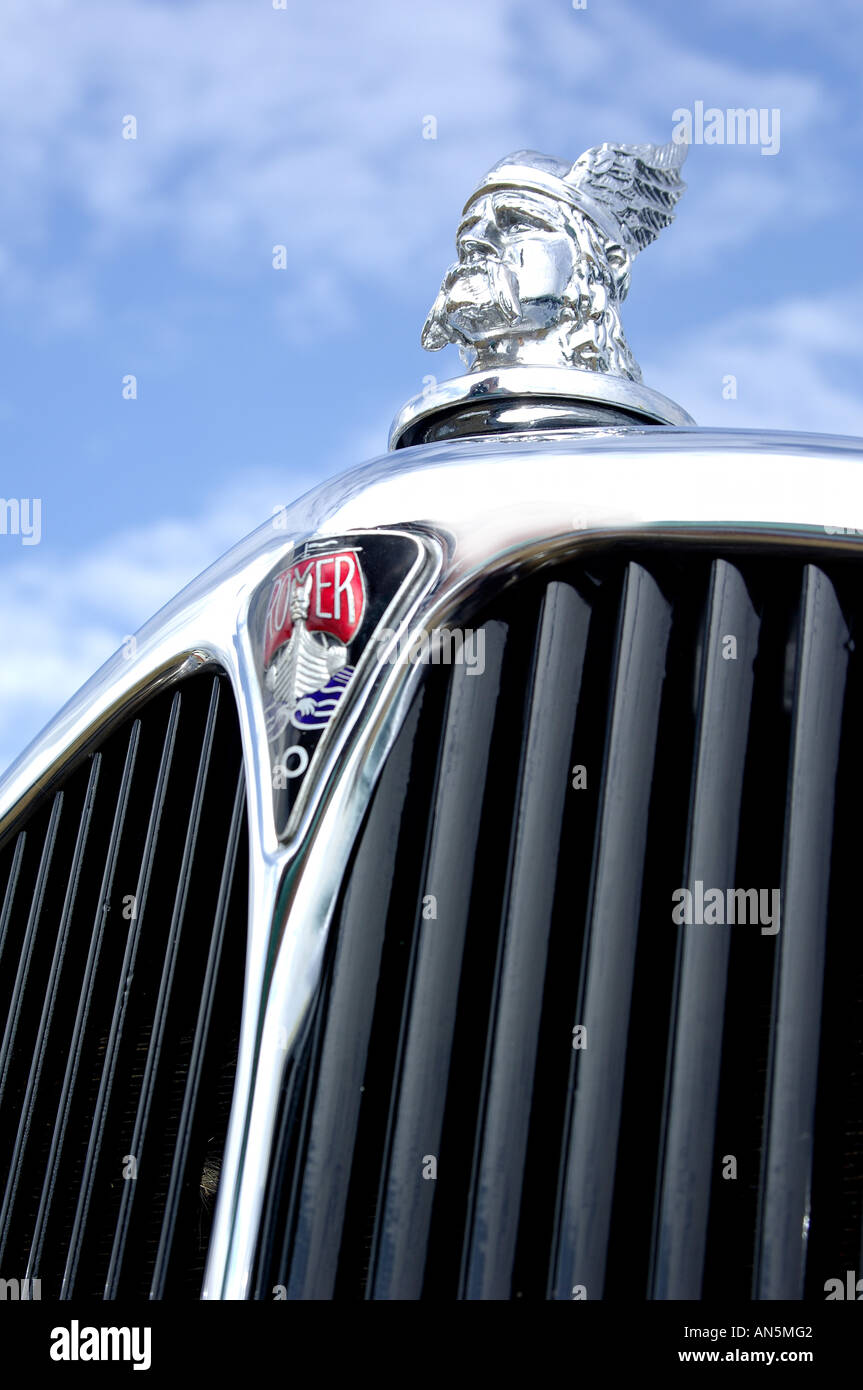Close up detail of front grill of vintage rover 10 classic car with viking emblem and blue cloudy sky Stock Photo