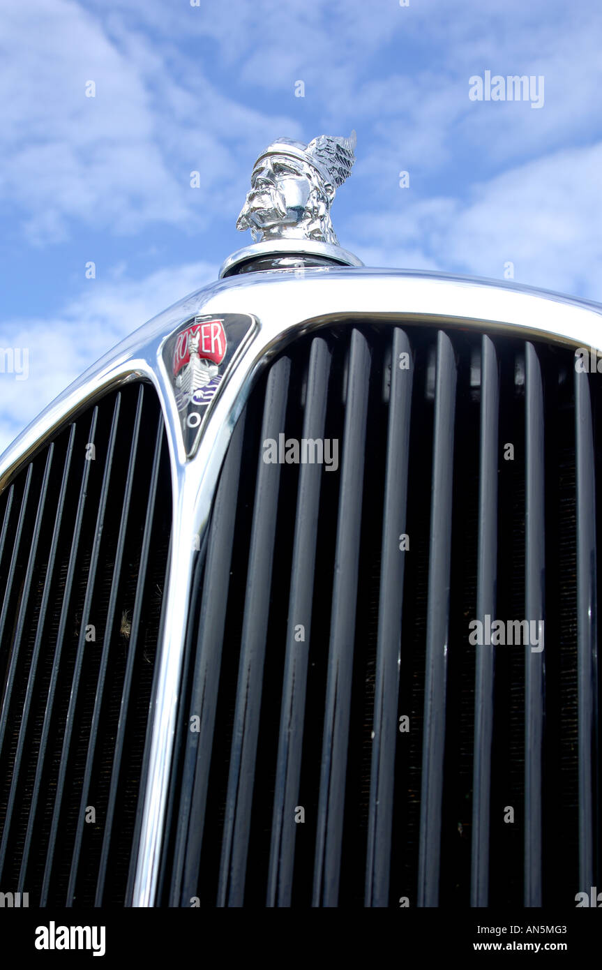 Close up detail of front grill of vintage rover 10 classic car with viking emblem and blue cloudy sky Stock Photo