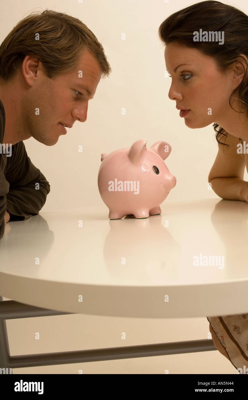 Portrait of a couple checking their piggy bank for money Stock Photo ...