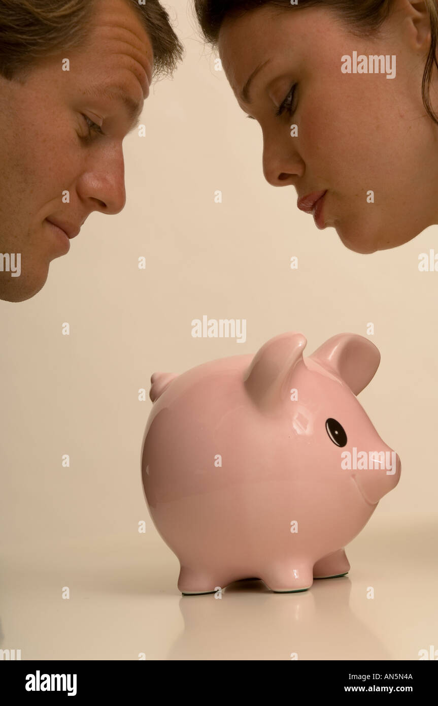 Portrait of a couple checking their piggy bank for money Stock Photo ...